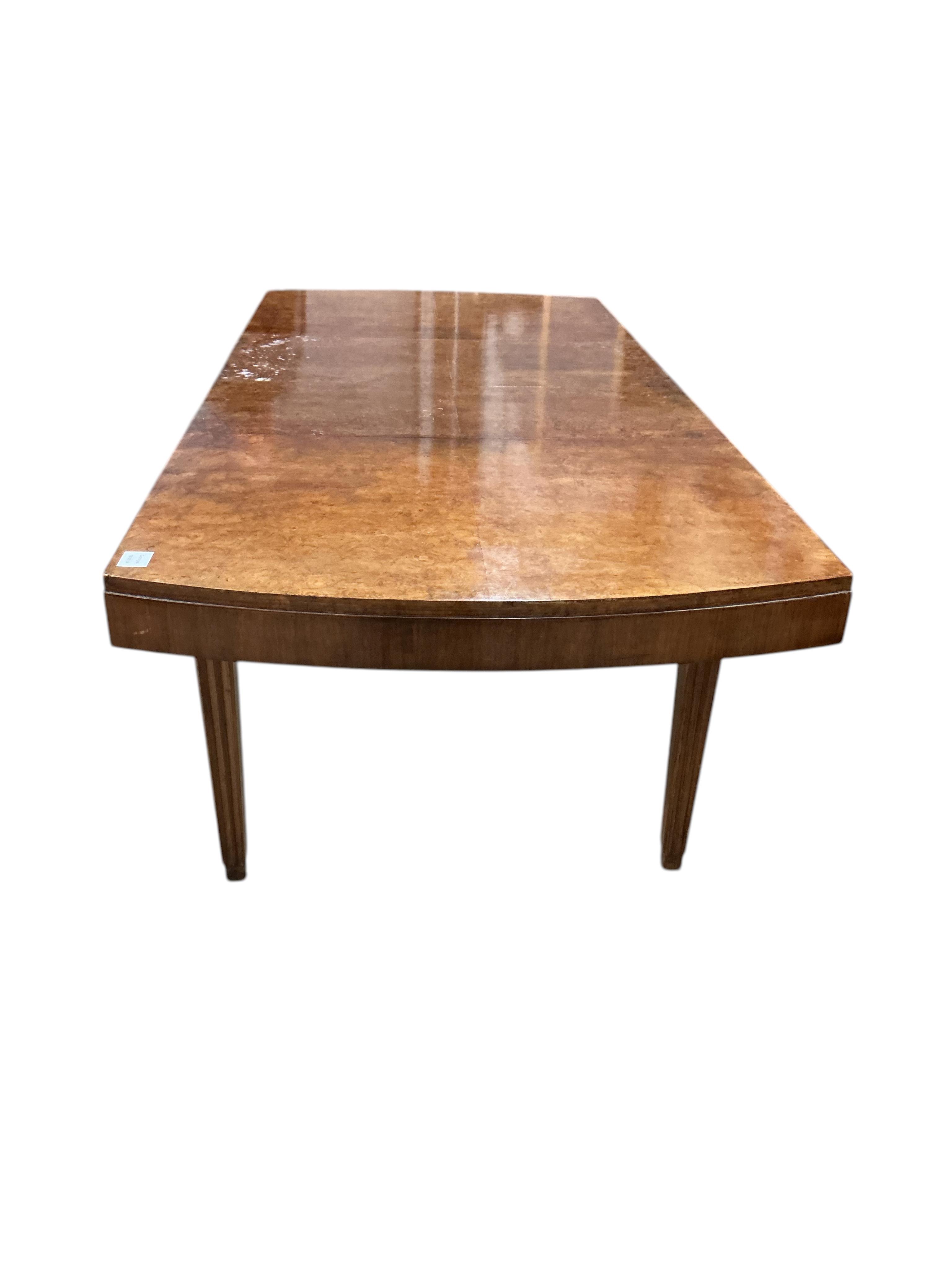 An Art Deco style beech and birds eye maple extending dining table, width 110cm, depth 84cm, height 75cm, and six similar chairs, two with arms